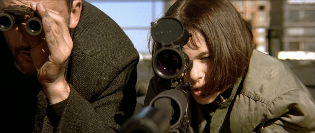 Wide shot frame from Léon — coat, gun, beard