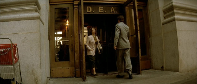 Wide shot frame from Léon — standing, dialogue, door
