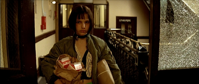 Wide shot frame from Léon — standing, door, face