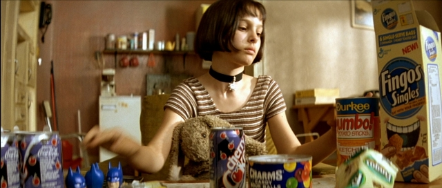 Wide shot frame from Léon — sitting, kitchen, food