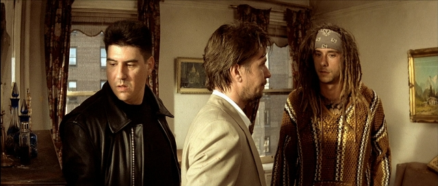 Wide shot frame from Léon — standing, room, suit