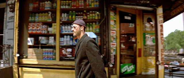 Wide shot frame from Léon — standing, street, beard