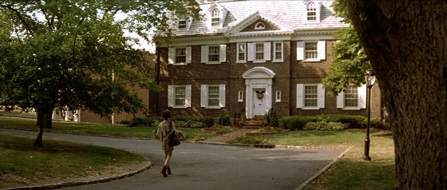 Wide shot frame from Léon — walking, door, street