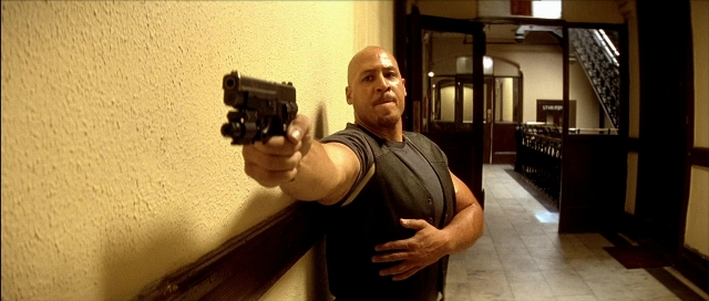 Wide shot frame from Léon — standing, hand, gun