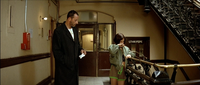 Frame from Léon — standing, door, fire