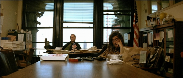 Wide shot frame from Léon — sitting, room, table