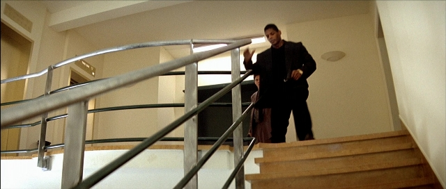 Frame from Léon — walking, hand, suit