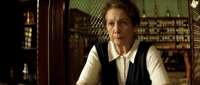 Wide shot frame from Léon — sitting, room, table