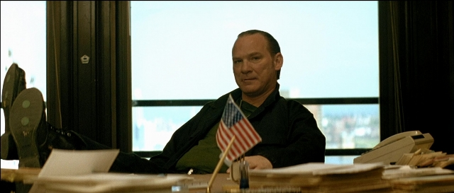 Wide shot frame from Léon — sitting, room, phone