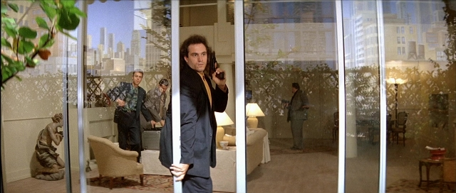 Wide shot frame from Léon — standing, room, phone