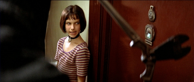 Wide shot frame from Léon — standing, room, door