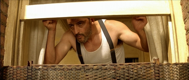 Wide shot frame from Léon — room, beard, mustache