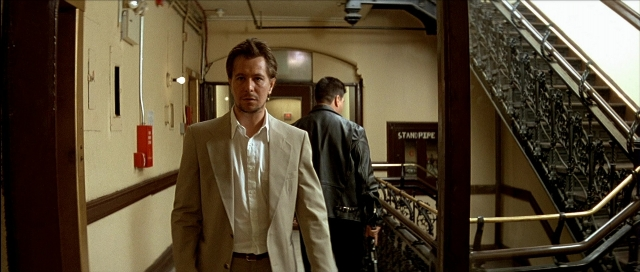 Wide shot frame from Léon — walking, fire, suit