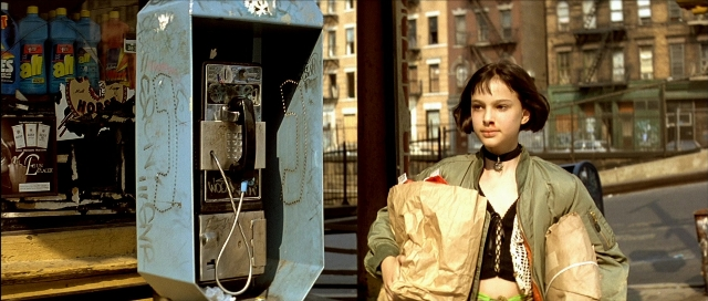 Wide shot frame from Léon — standing, street, jacket