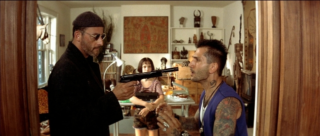 Wide shot frame from Léon — standing, room, dialogue