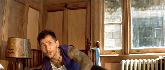 Wide shot frame from Léon — sitting, room, bed
