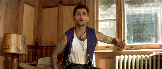 Wide shot frame from Léon — standing, room, dialogue