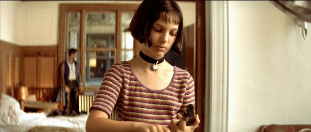 Wide shot frame from Léon — standing, room, bed