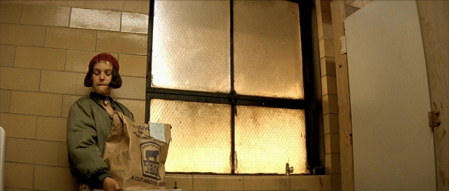 Wide shot frame from Léon — standing, room, door