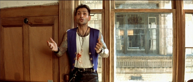 Wide shot frame from Léon — standing, room, door