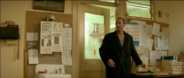 Wide shot frame from Léon — standing, room, phone