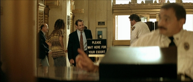 Wide shot frame from Léon — standing, room, dialogue