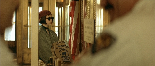 Wide shot frame from Léon — standing, room, door