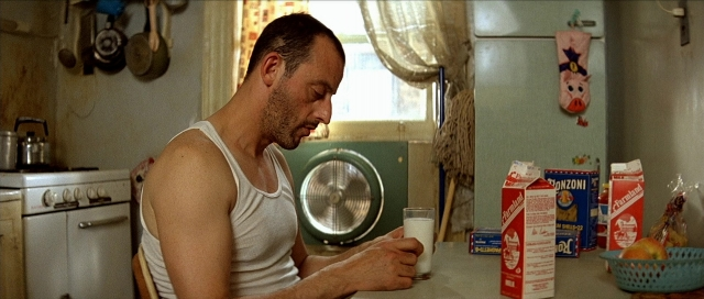 Wide shot frame from Léon — sitting, kitchen, food