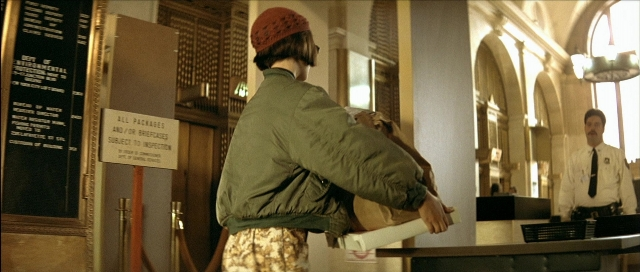 Wide shot frame from Léon — standing, uniform, hand