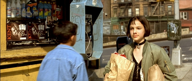 Wide shot frame from Léon — standing, street, hand
