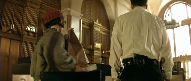 Wide shot frame from Léon — standing, hand, shirt