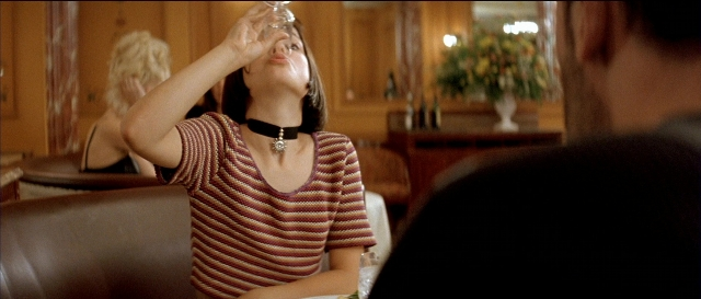 Wide shot frame from Léon — sitting, table, couch
