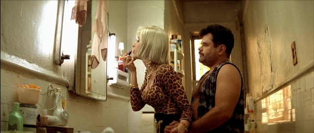 Wide shot frame from Léon — standing, mirror, hand