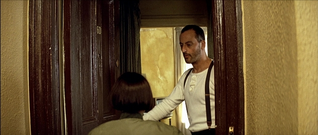 Wide shot frame from Léon — sitting, standing, door
