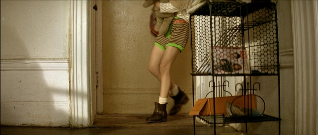 Wide shot frame from Léon — standing, door, person