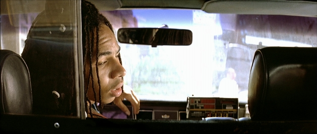 Wide shot frame from Léon — sitting, street, mirror
