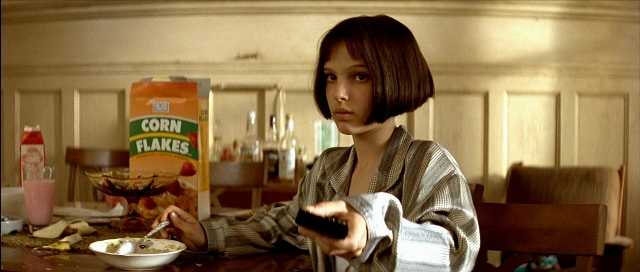 Wide shot frame from Léon — sitting, table, hand