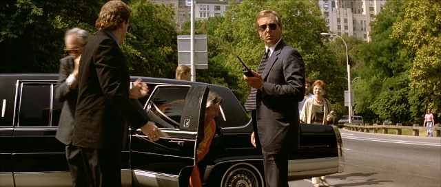 Wide shot frame from Léon — standing, dialogue, phone