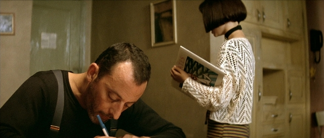 Wide shot frame from Léon — sitting, book, standing