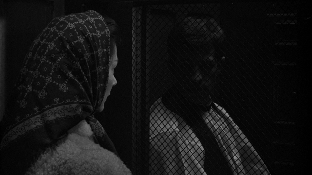 Frame from Léon Morin, prêtre — standing, face, person