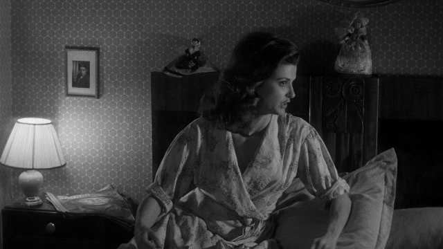 Wide shot frame from Léon Morin, prêtre — sitting, bed, house