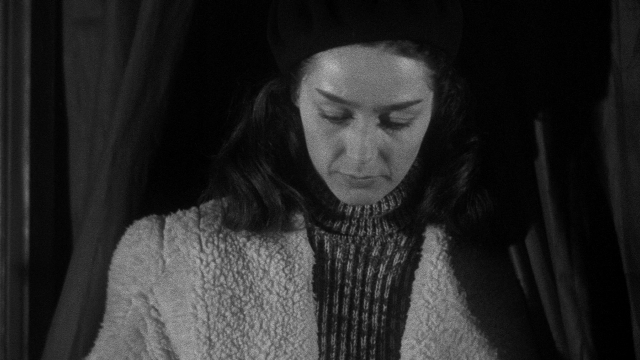 Medium shot frame from Léon Morin, prêtre — sitting, face, hair
