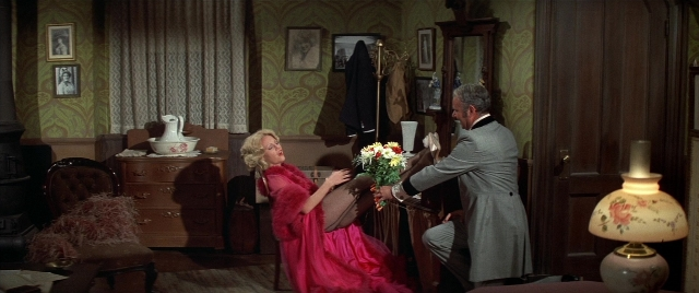 Wide shot frame from Blazing Saddles — standing, room, suit