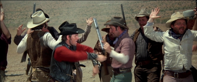 Wide shot frame from Blazing Saddles — standing, hat, hand