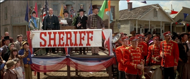 Wide shot frame from Blazing Saddles — standing, flag, person