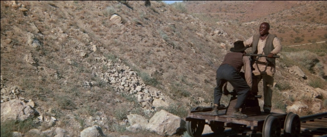 Wide shot frame from Blazing Saddles — standing, hat, shirt