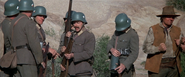 Frame from Blazing Saddles — standing, dialogue, gun