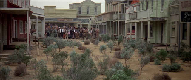 Wide shot frame from Blazing Saddles — standing, walking, house