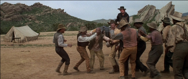 Wide shot frame from Blazing Saddles — standing, table, tent