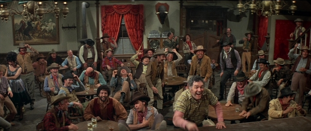 Wide shot frame from Blazing Saddles — sitting, standing, room